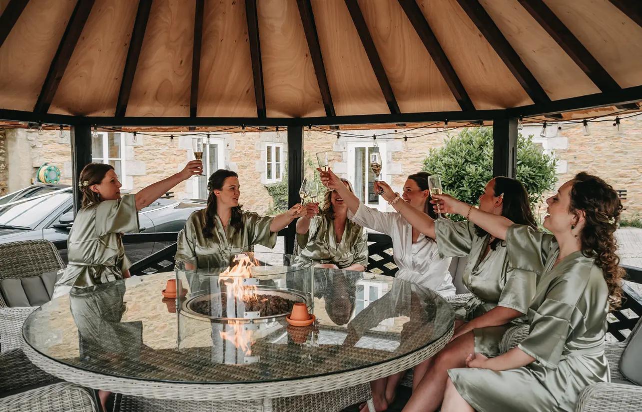 The bridal party raising their glasses in the courtyard
