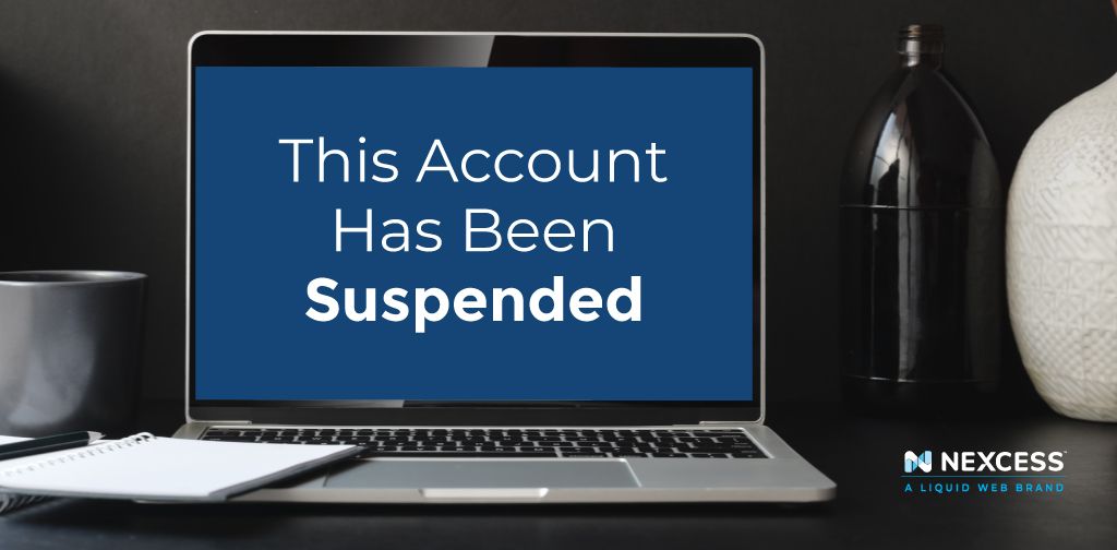 Laptop on a desk with This Account Has Been Suspended on the screen
