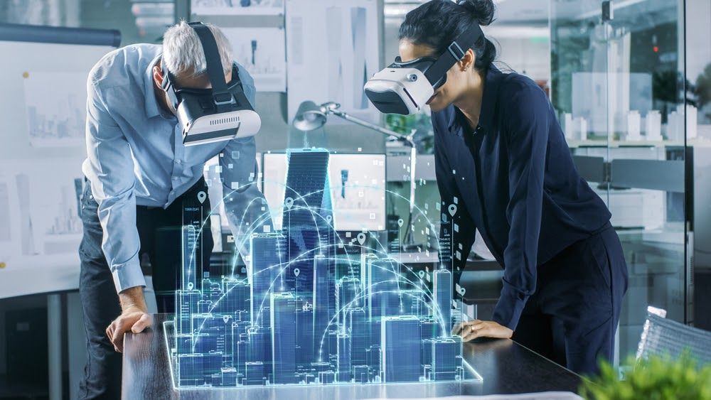 Two people with VR glasses looking at a virtual city.