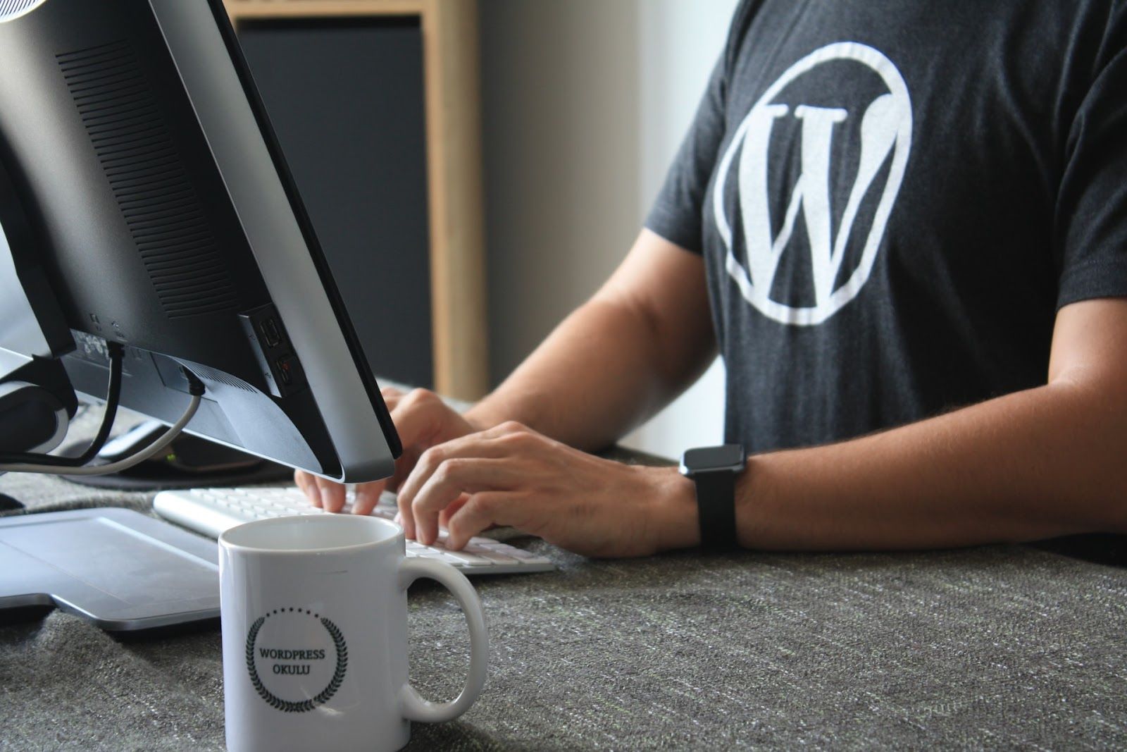 Person Wearing Black Tee Shirt With WordPress Logo as Etsy Alternative.