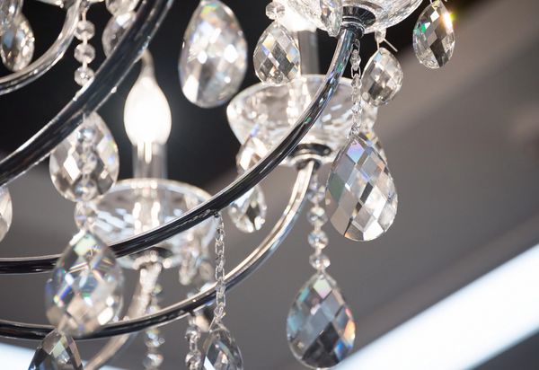 Crystal chandelier with hanging glass prisms in a modern showroom display