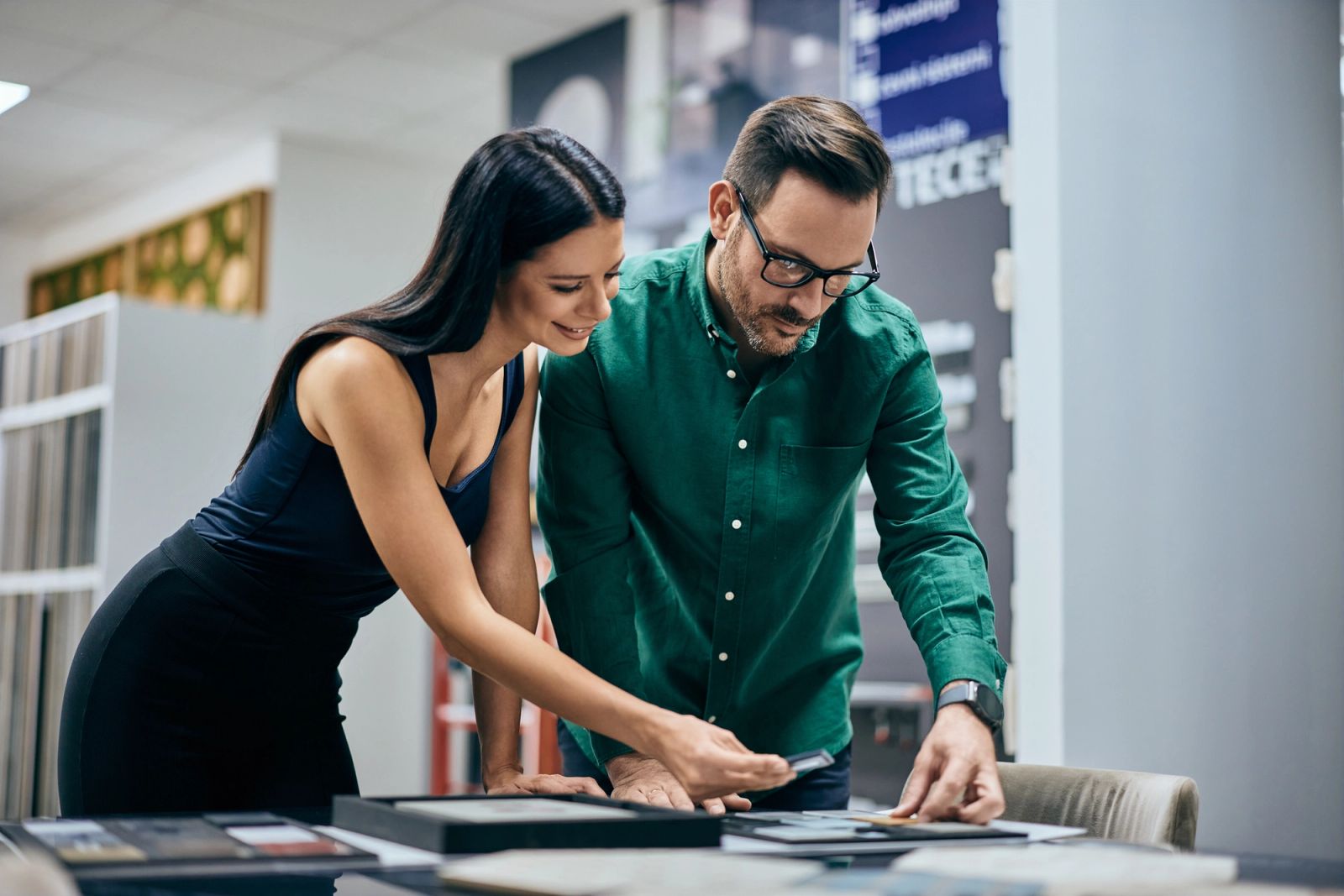 Shopper reviewing product specifications with a retail associate in local showroom
