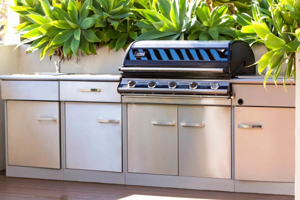 Stainless steel outdoor grill and kitchen cooking station on backyard patio