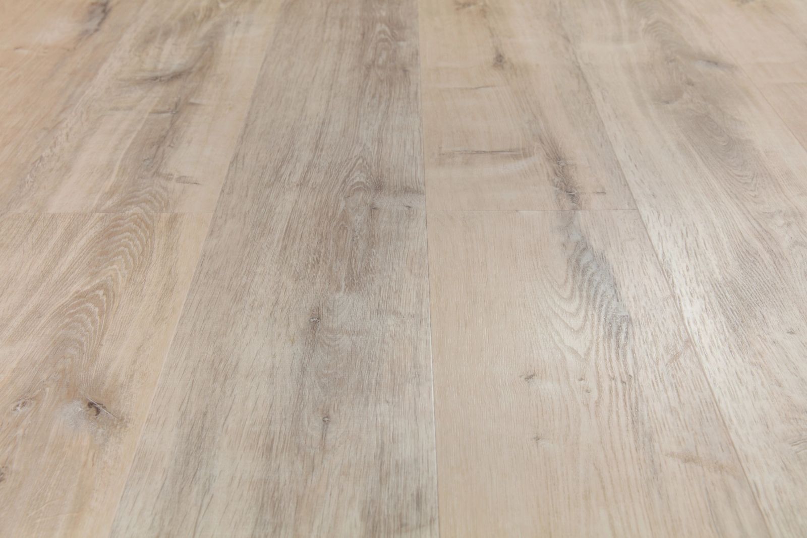 Luxury vinyl plank flooring with a light wood appearance installed in a modern interior.