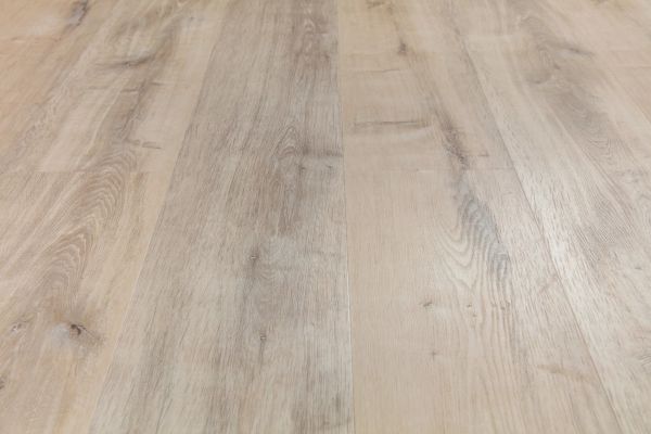 Luxury vinyl plank flooring with a light wood appearance installed in a modern interior.