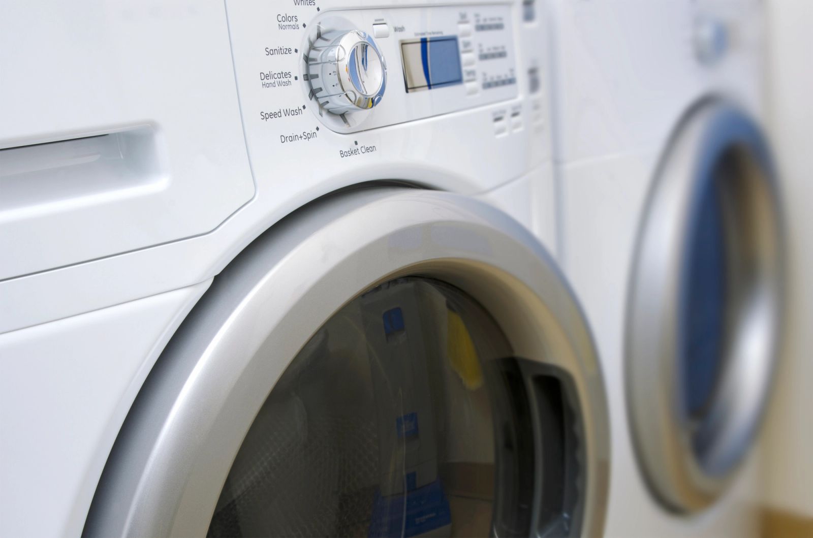 Front-load washer and dryer set displayed in an appliance showroom