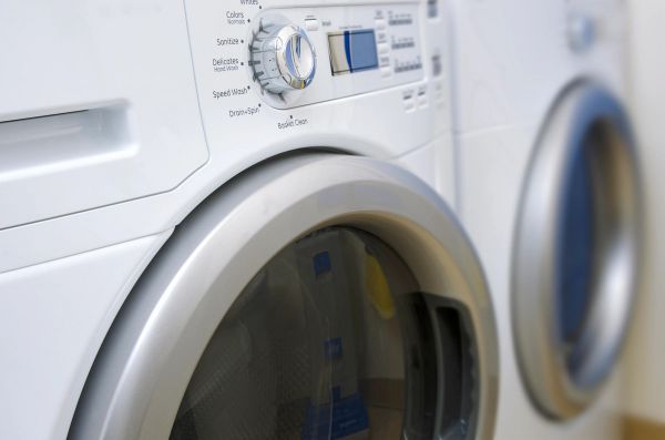 Front-load washer and dryer set displayed in an appliance showroom