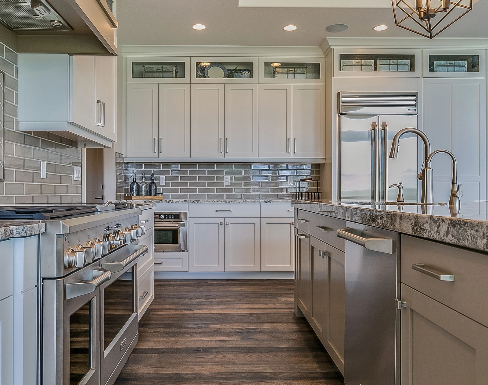 Modern kitchen showroom featuring stainless steel appliances including range, refrigerator, and dishwasher