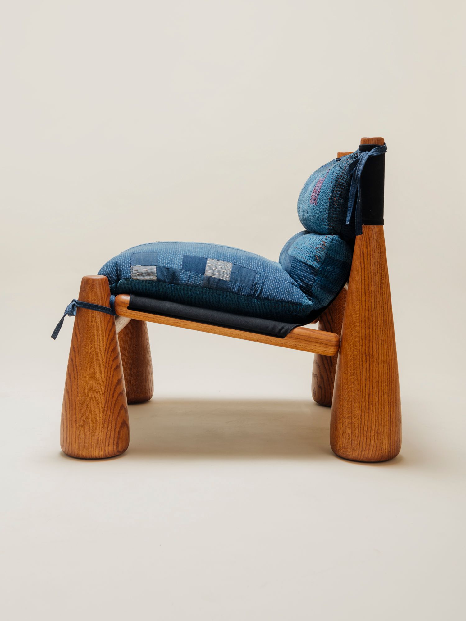 wood chair profile view with blue fabric patchwork