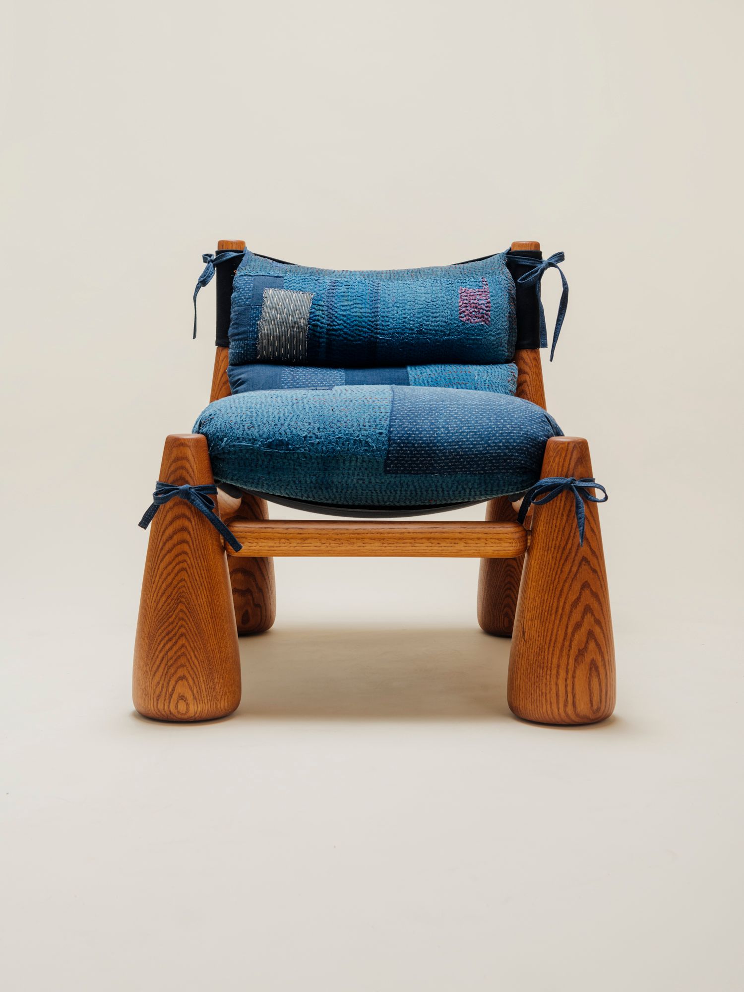 wood chair with patchwork fabric made from indigo kanthas