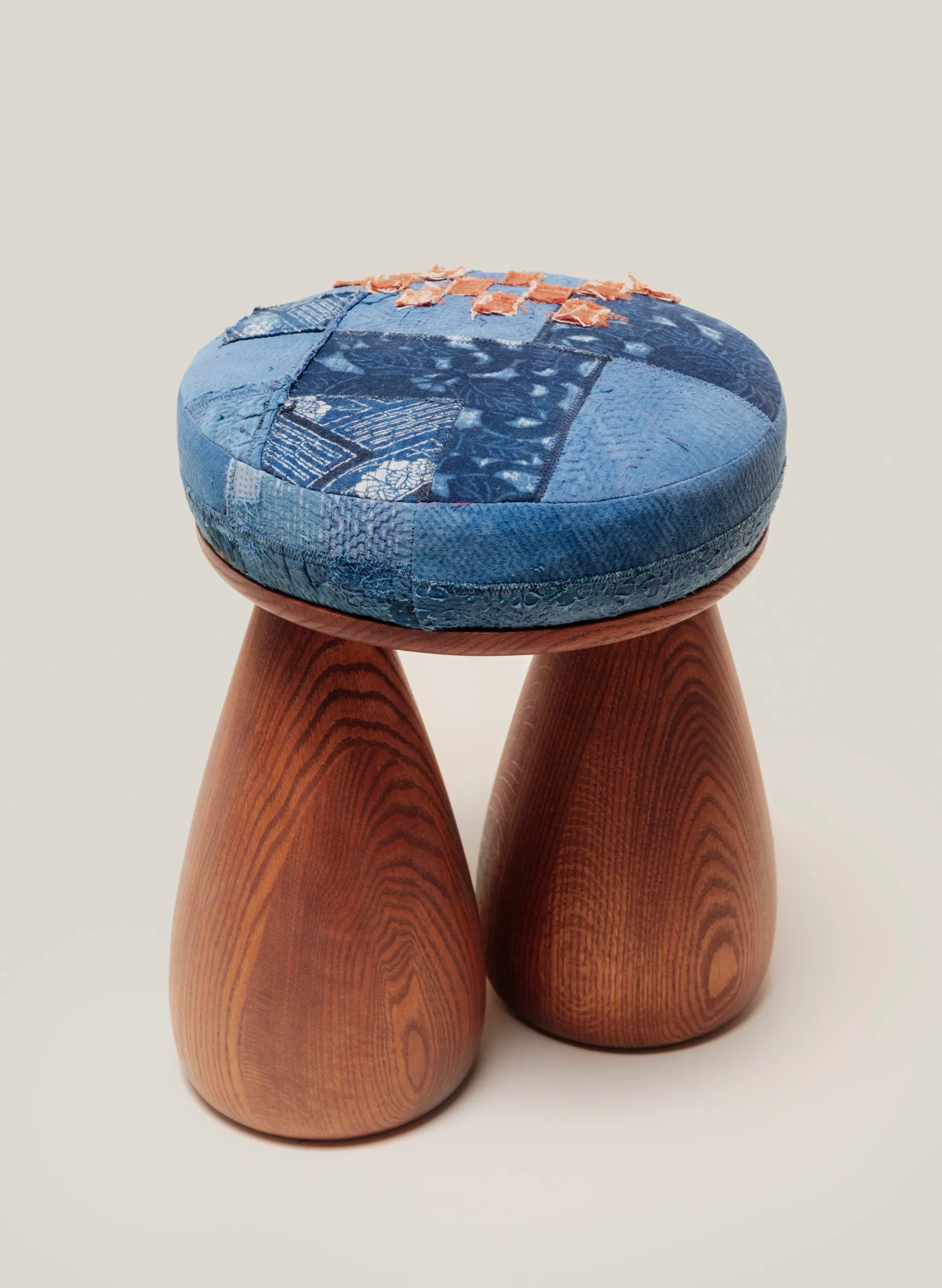 A plush stool and two legs in the shape of bell bottom jeans.