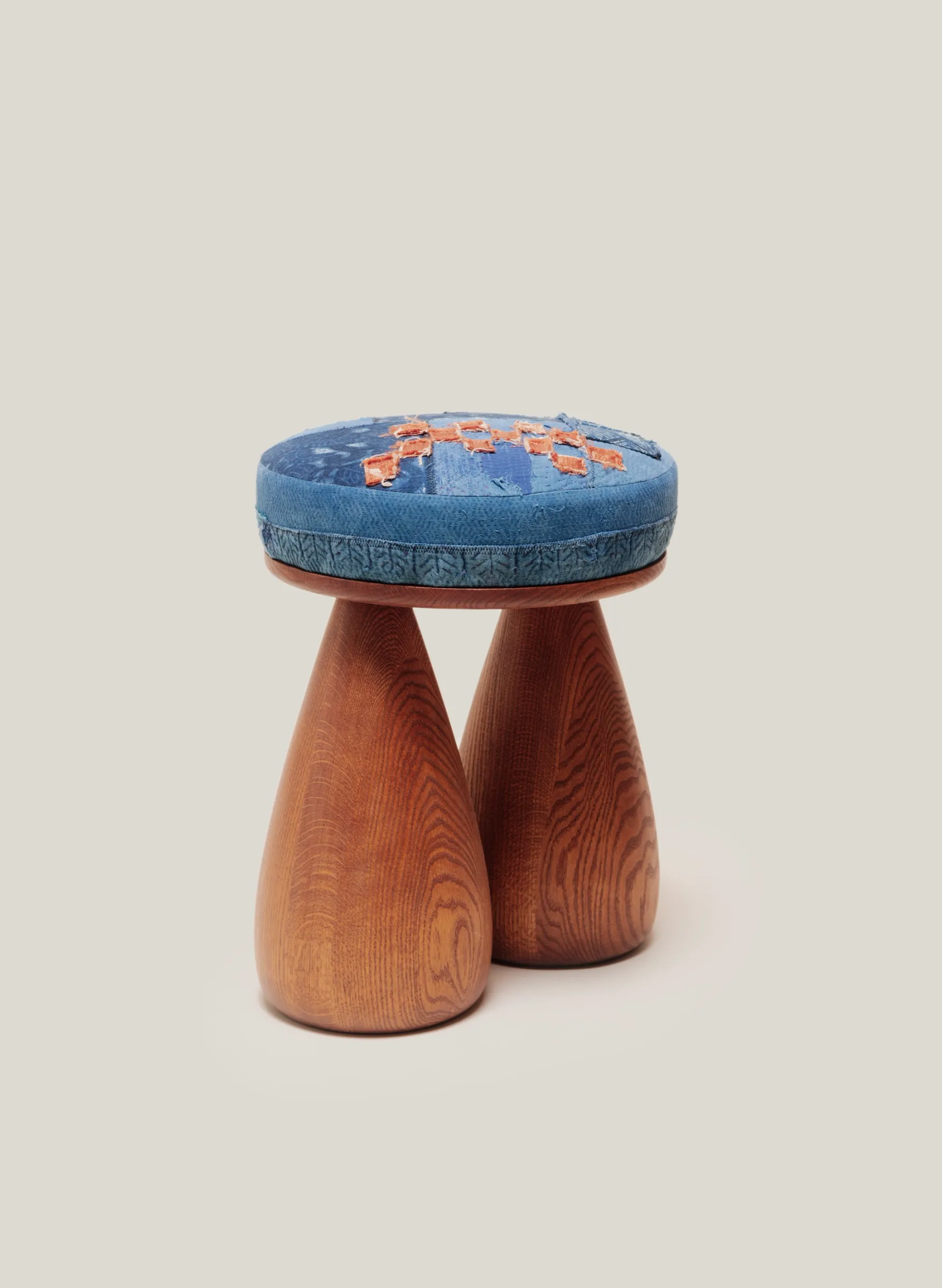A plush stool and two legs in the shape of bell bottom jeans.