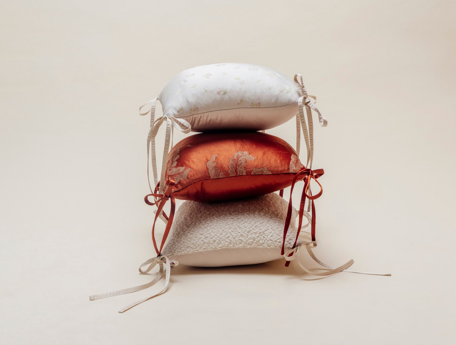 tie pillows stacked in various fabrics