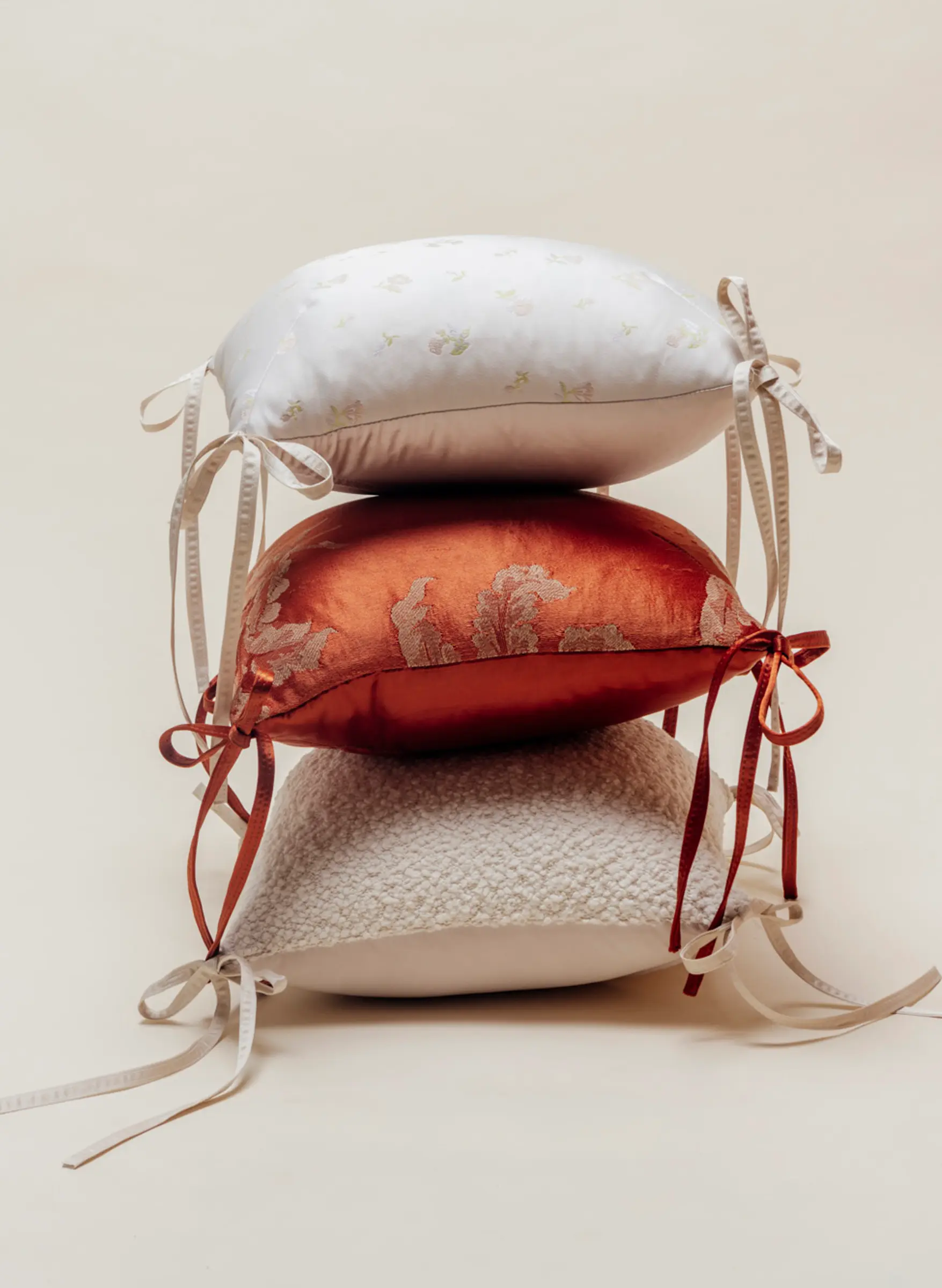 tie pillows stacked in various fabrics