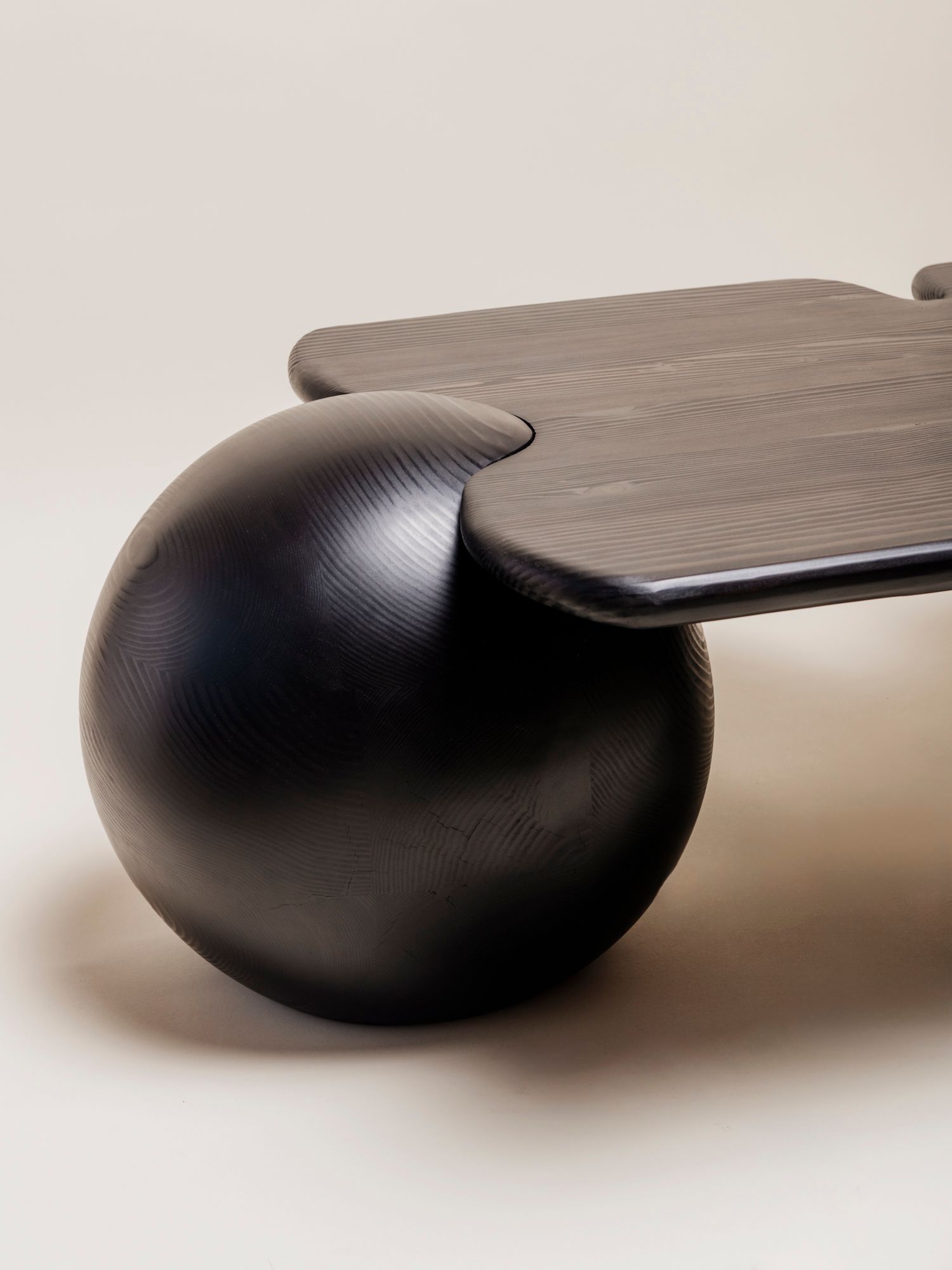 close. up of table with sphere legs and wood top