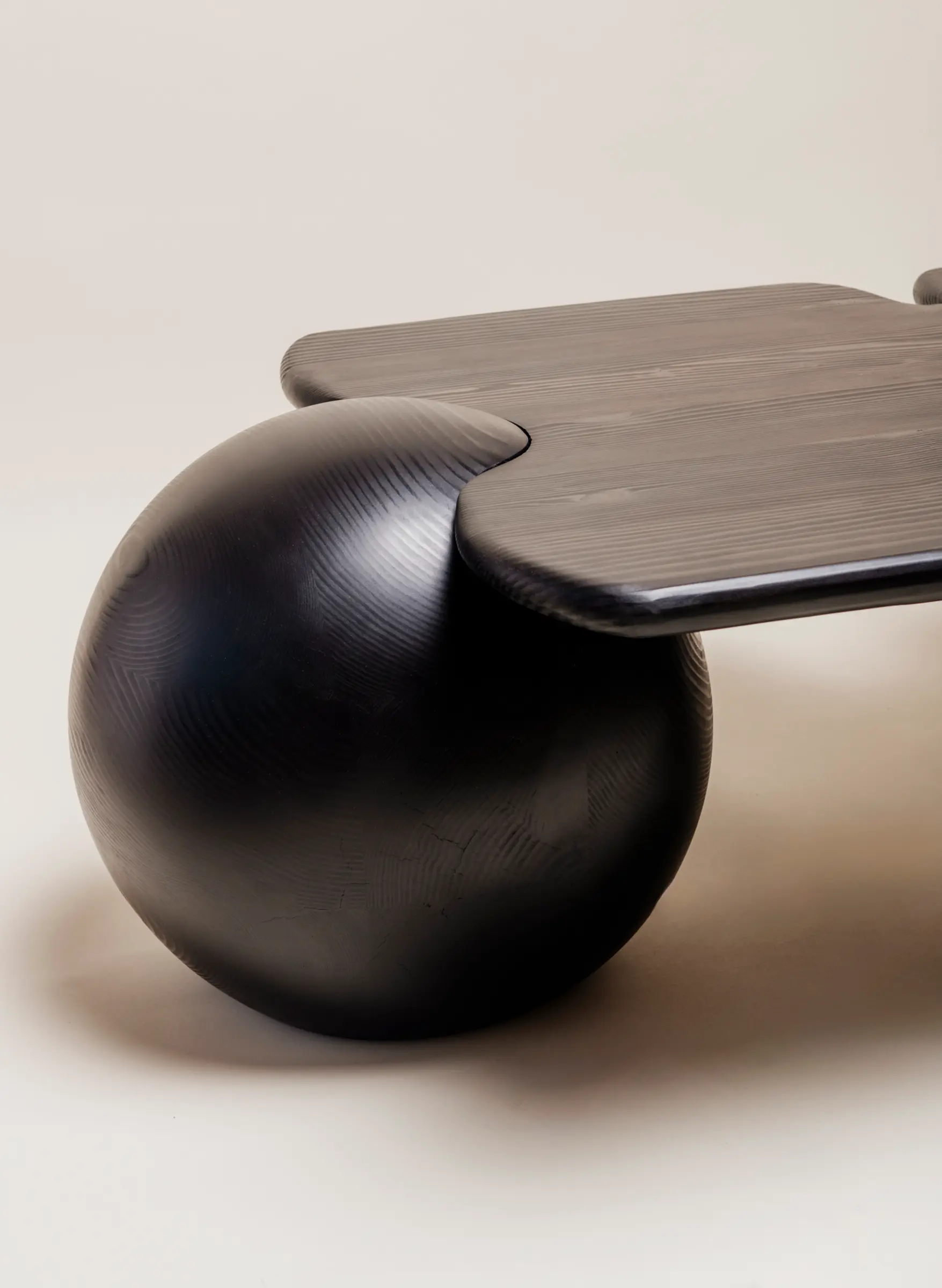 close. up of table with sphere legs and wood top