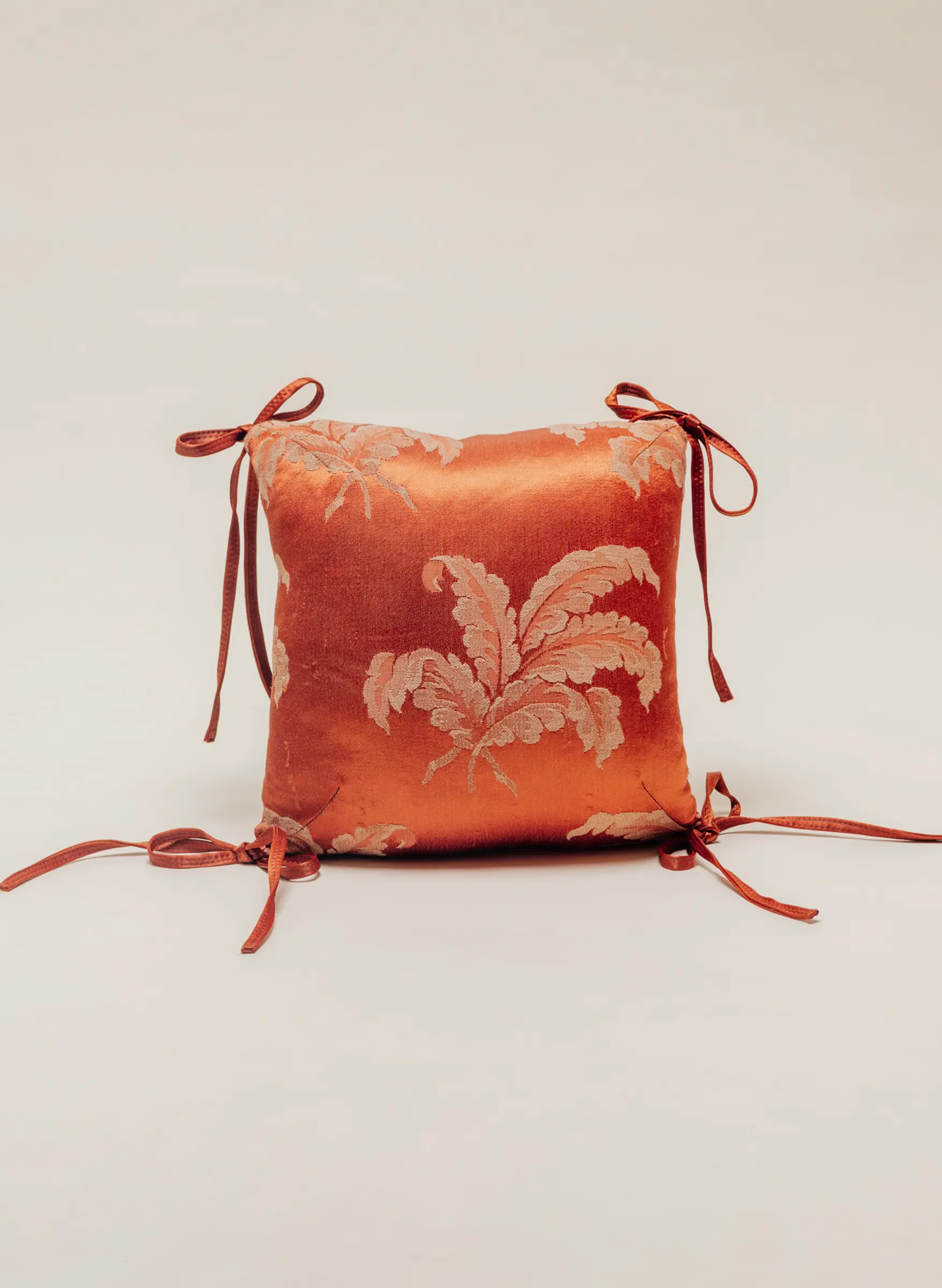 Orange silk pillow on clean background