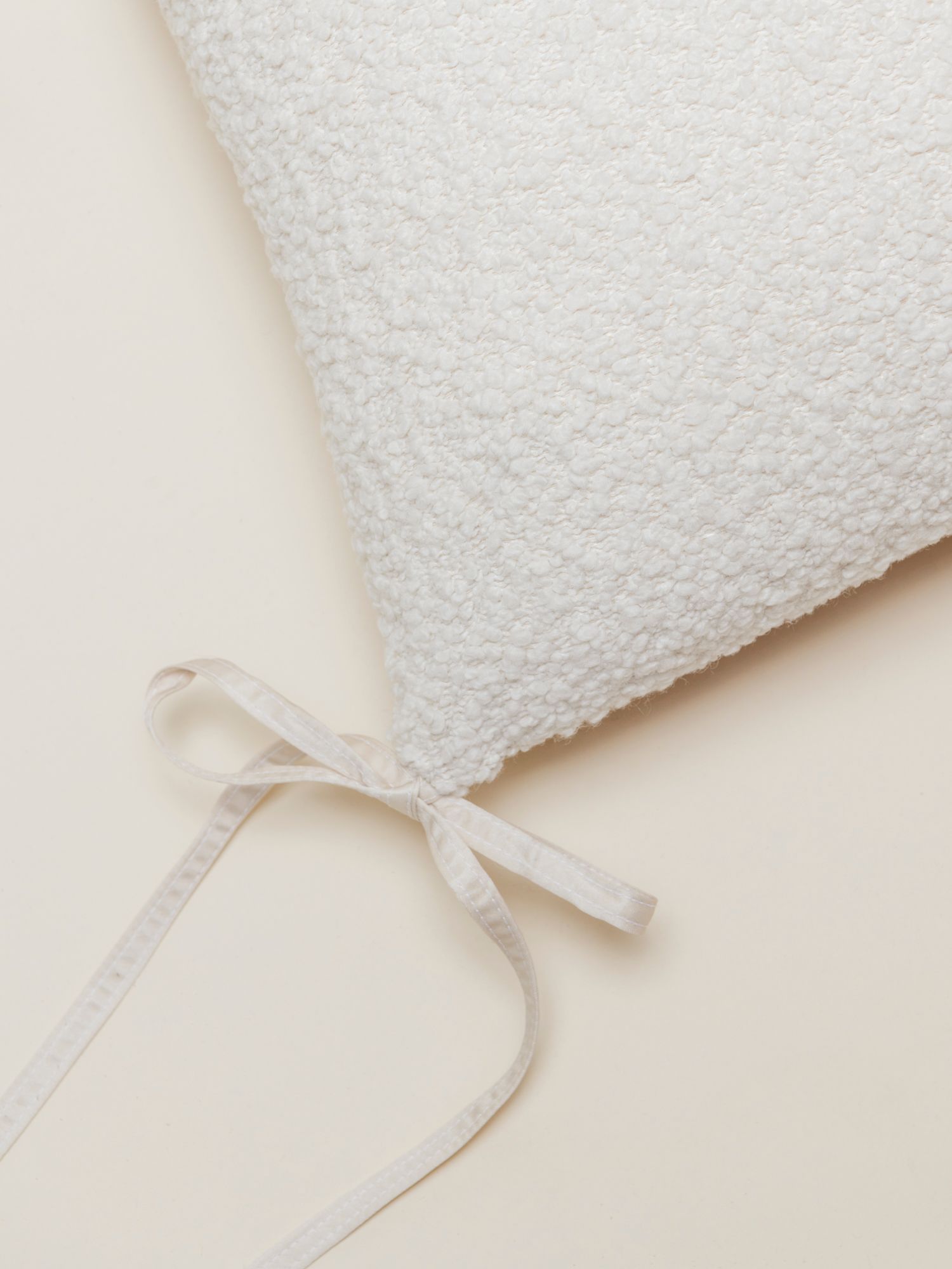 detail of pillow with boucle fabric in white