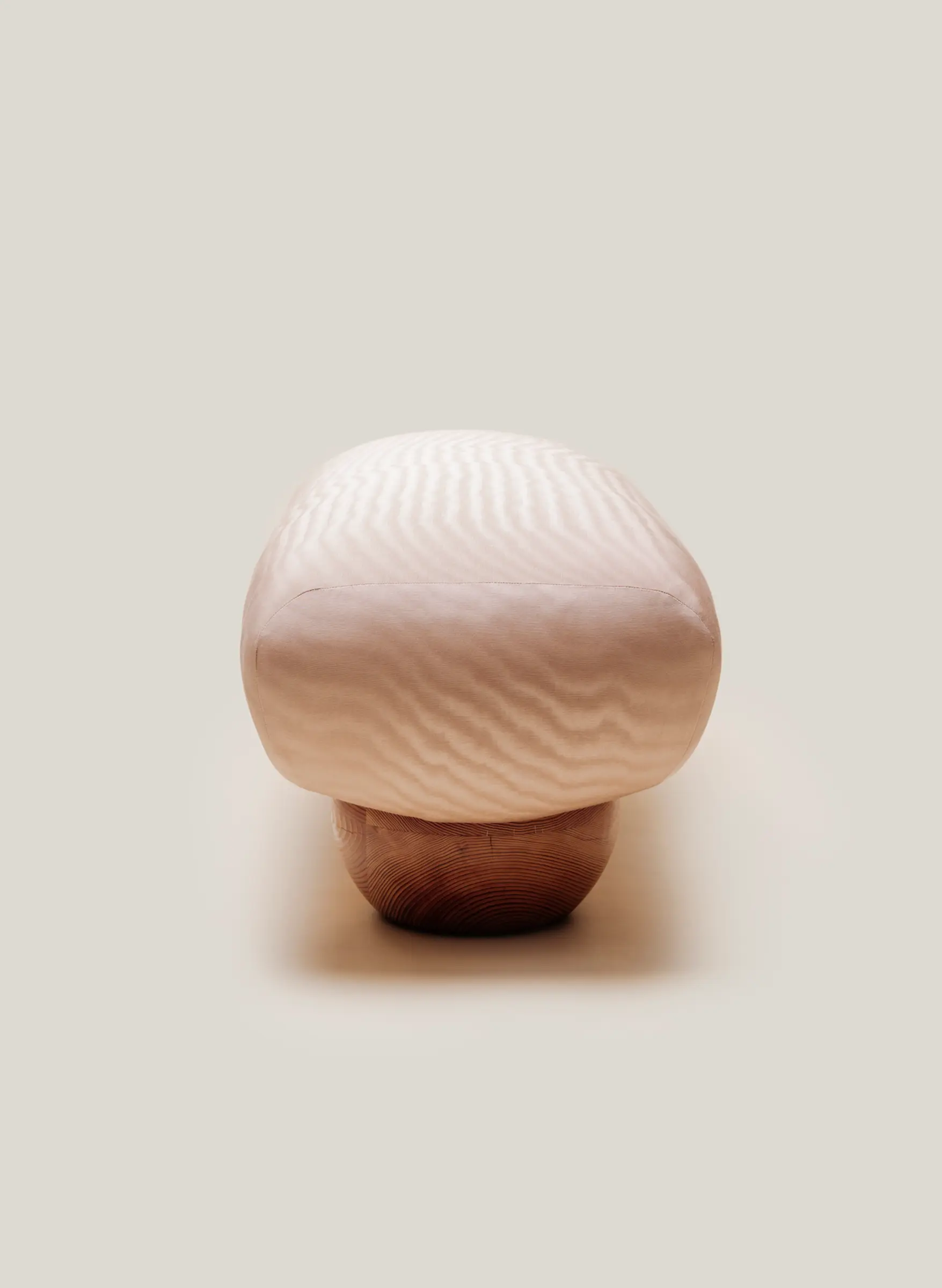 side profile view of pink bench with wood legs