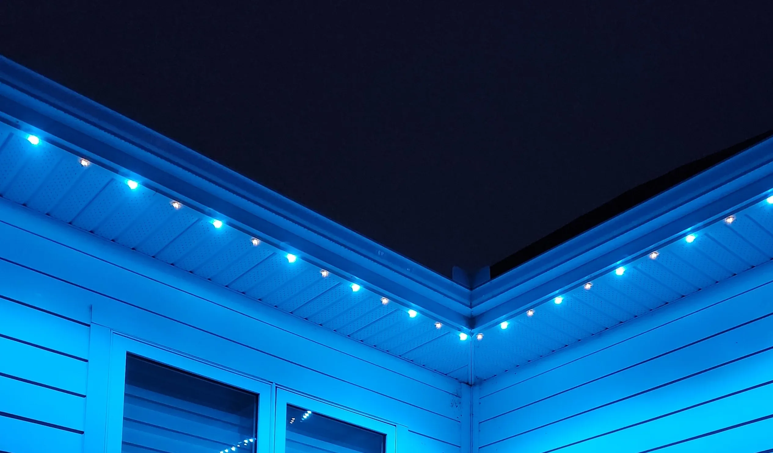 Close up of recessed puck lighting under eaves dense spacing