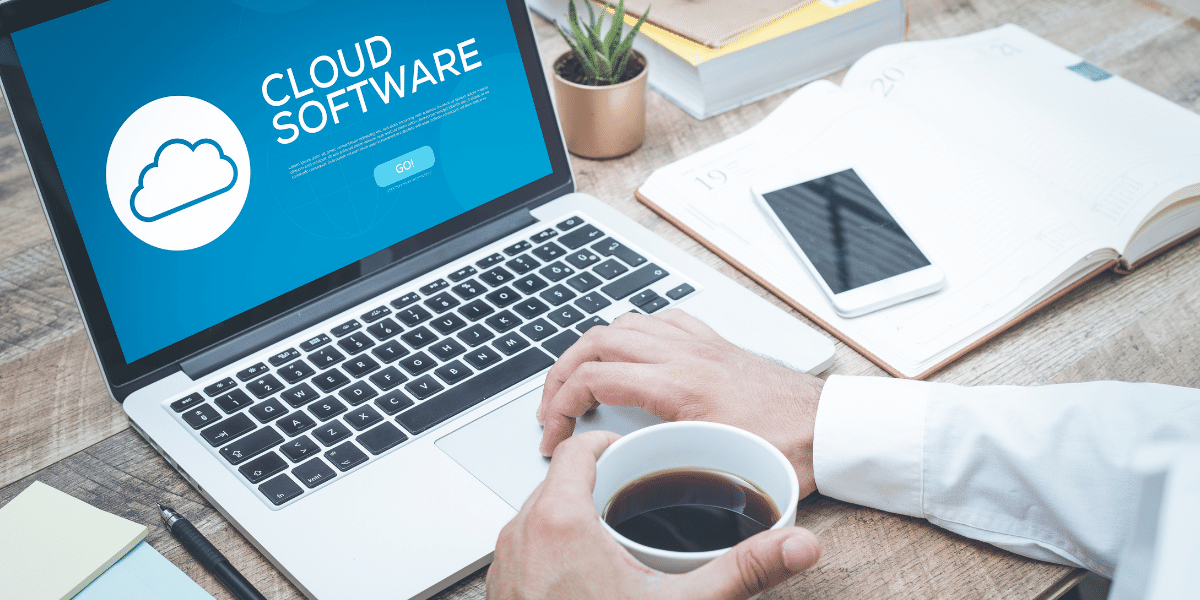 Professional drinking coffee and typing on laptop using cloud software