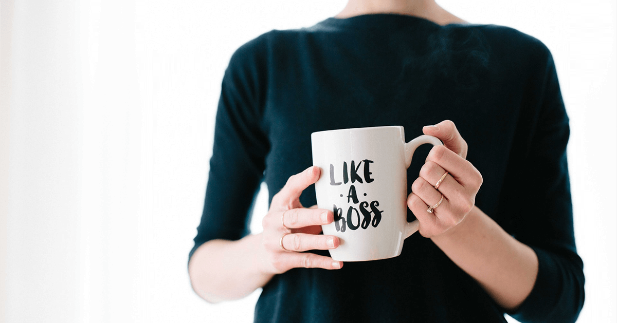 Woman holding coffee mug that states "Like a Boss"