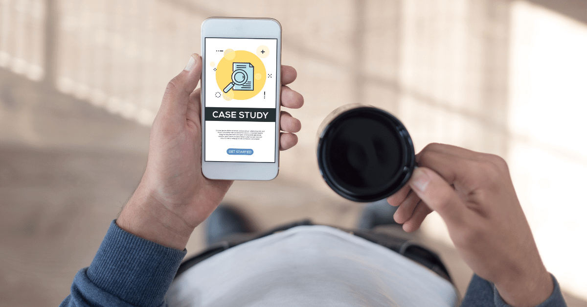 Professional holding iPhone and reviewing case study while drinking coffee