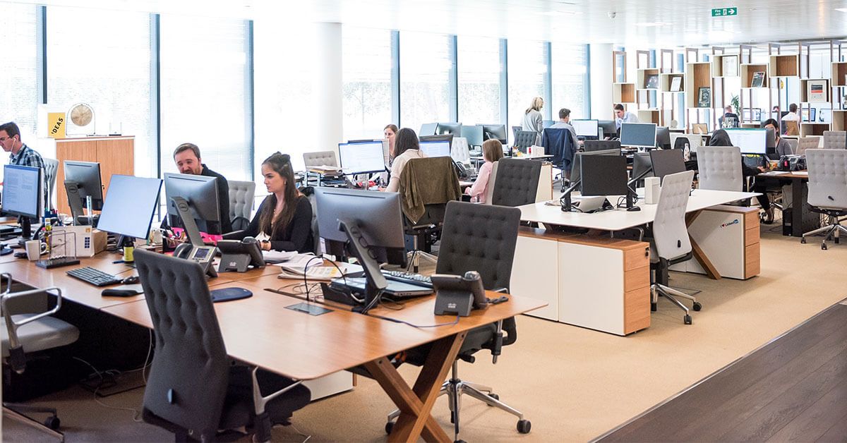 Customer support agents working in large office space