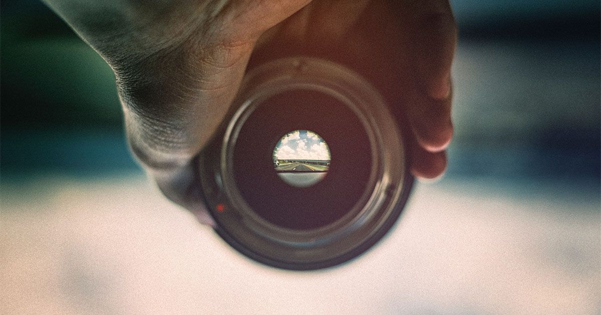 Man holding cameral lens for clear view