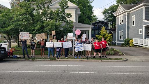 A crowd of people holding signs