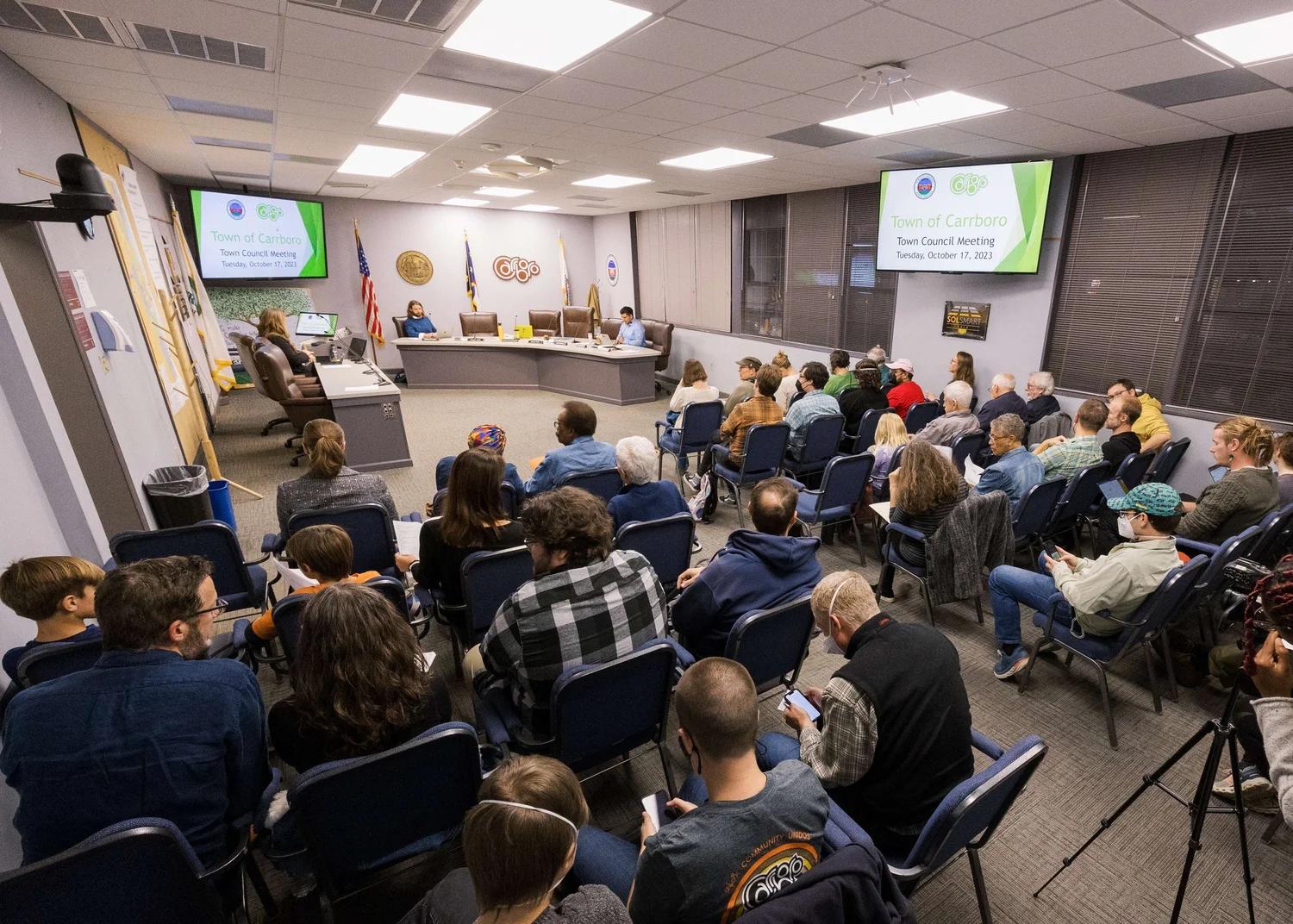 A crowd of people listening in on a Carrboro Town Council session