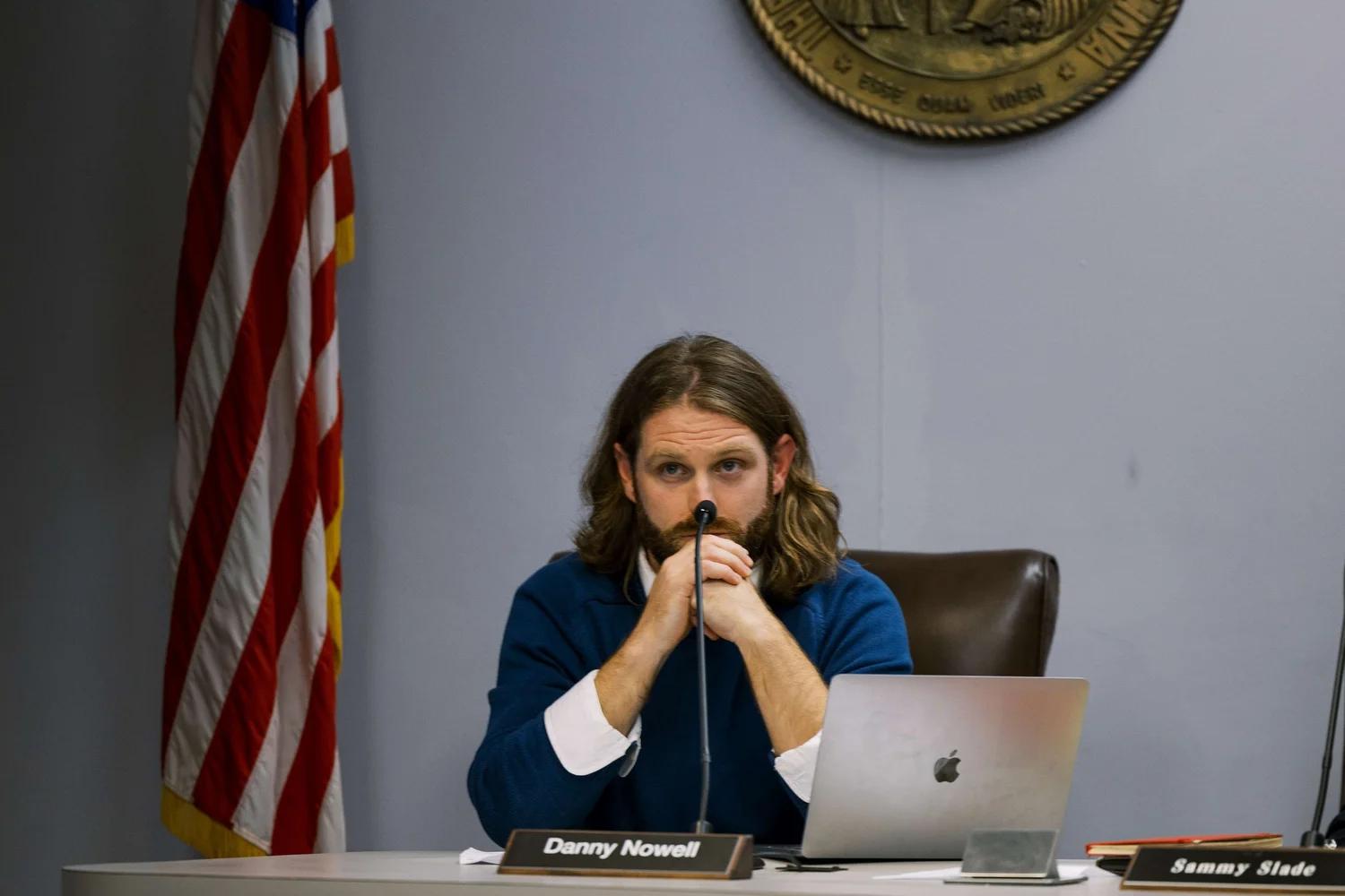 Danny Nowell sitting behind the bench at the Carrboro Town Council.