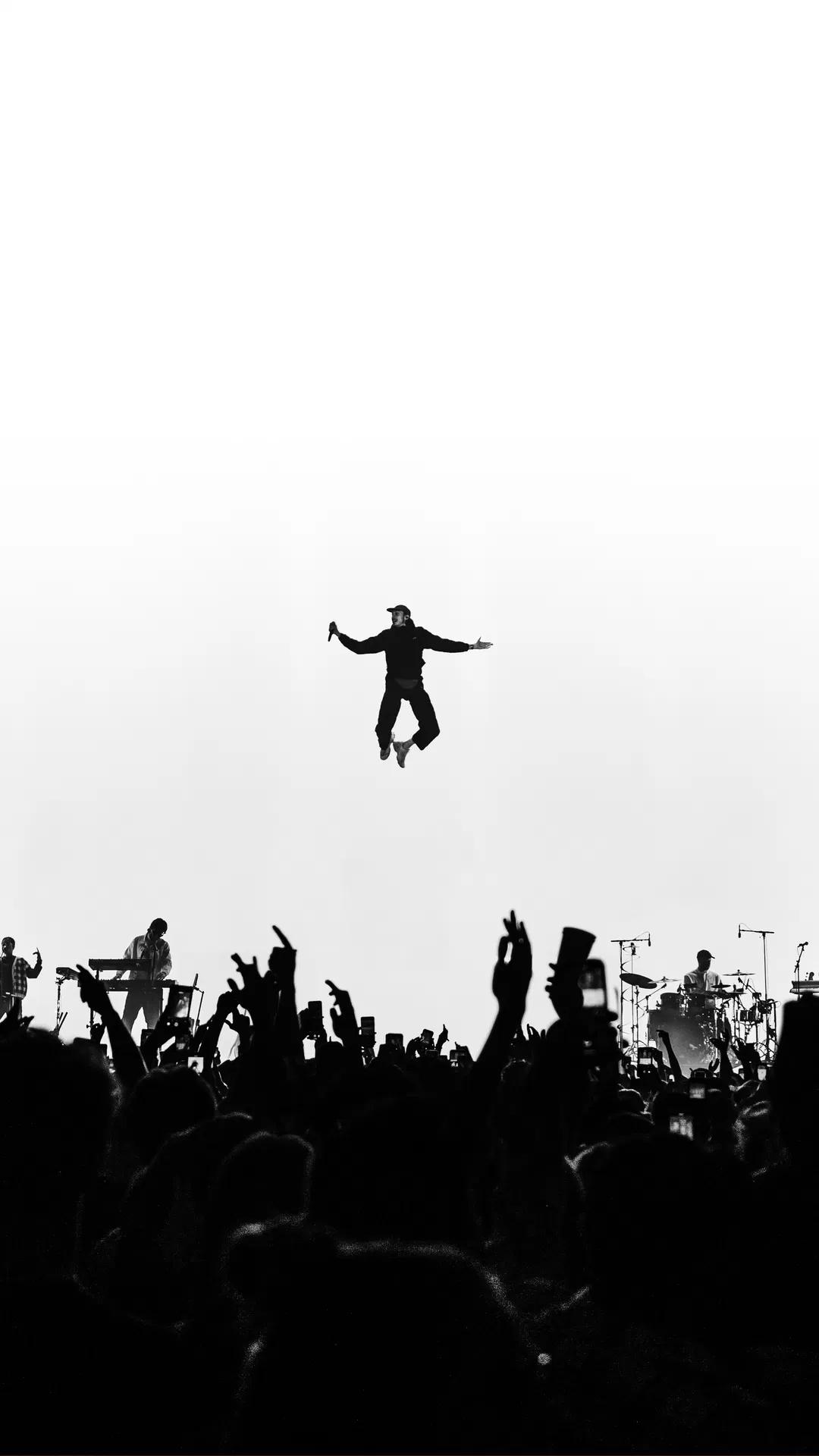 White & Black Photo of Roméo Elvis in the air