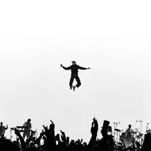 White & Black Photo of Roméo Elvis in the air