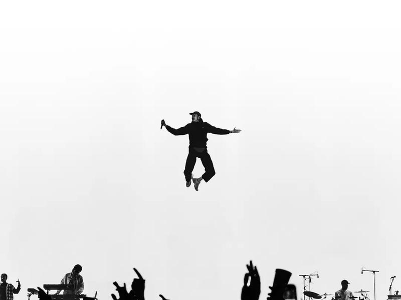 White & Black Photo of Roméo Elvis in the air