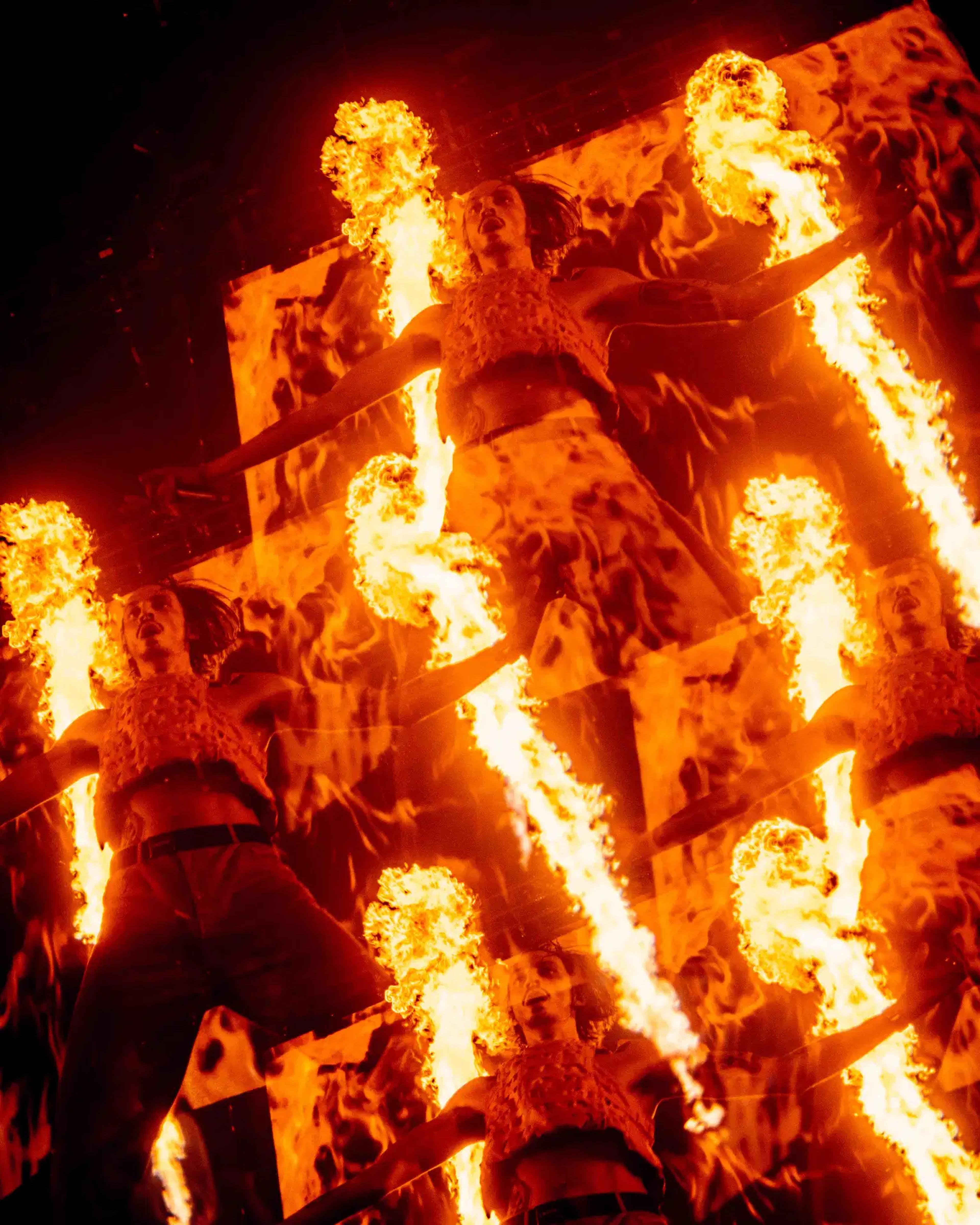 Roméo Elvis with fire behind him