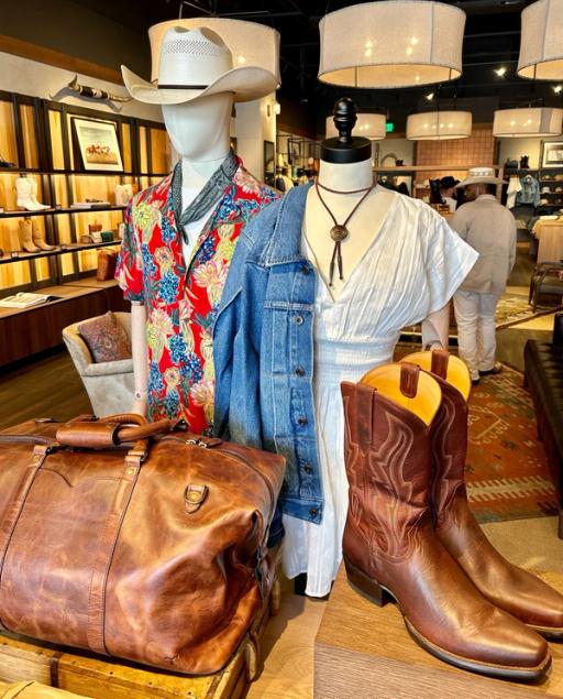 Interior of a boot store with shelves of various styles of western clothing 