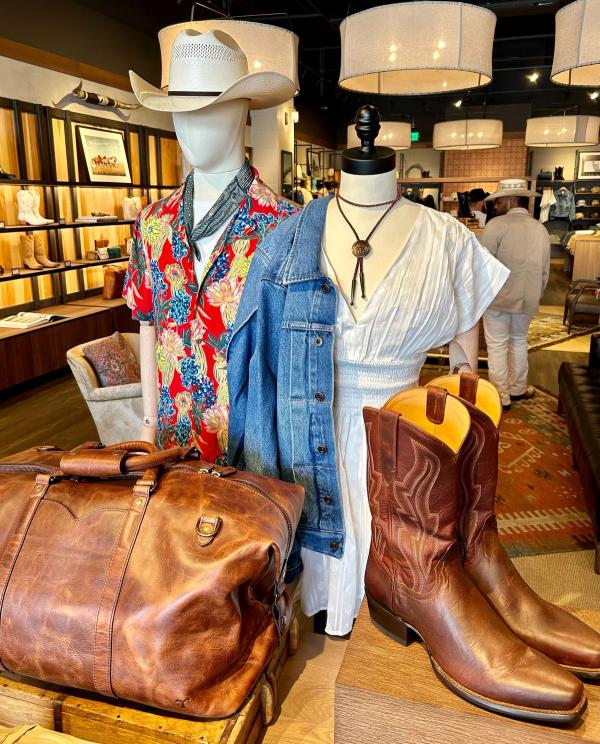 Interior of a boot store with shelves of various styles of western clothing