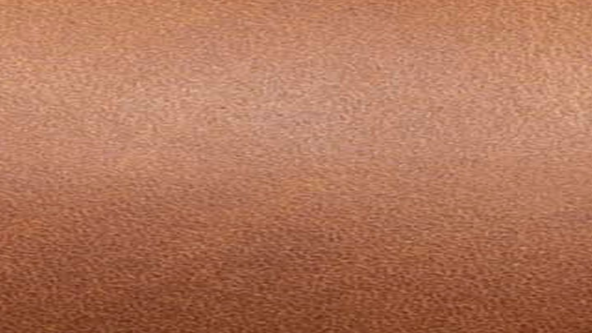 Brown textured surface with a slightly mottled appearance.