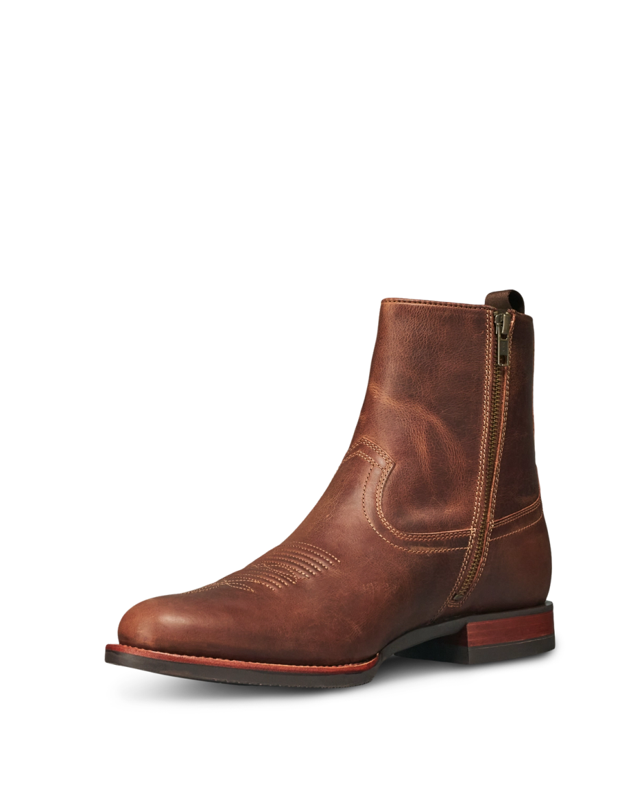 The Wayne in Maplewood Cowhide. Brown leather ankle boot with side zipper, low stacked heel, and decorative stitching on the upper, crafted from The Wayne Cowhide, displayed on a white background.