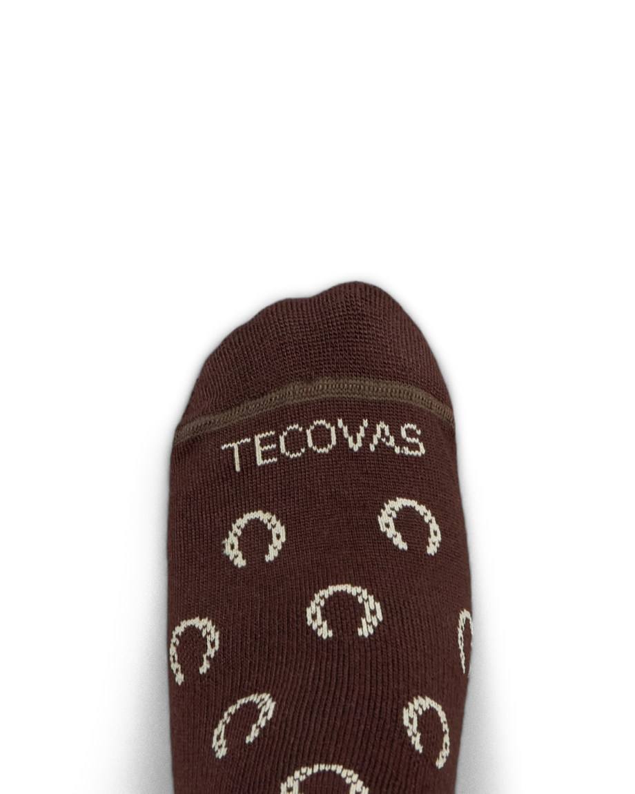 Brown sock with the word "Tecovas" and a pattern of light-colored horseshoes on the top, photographed against a white background.