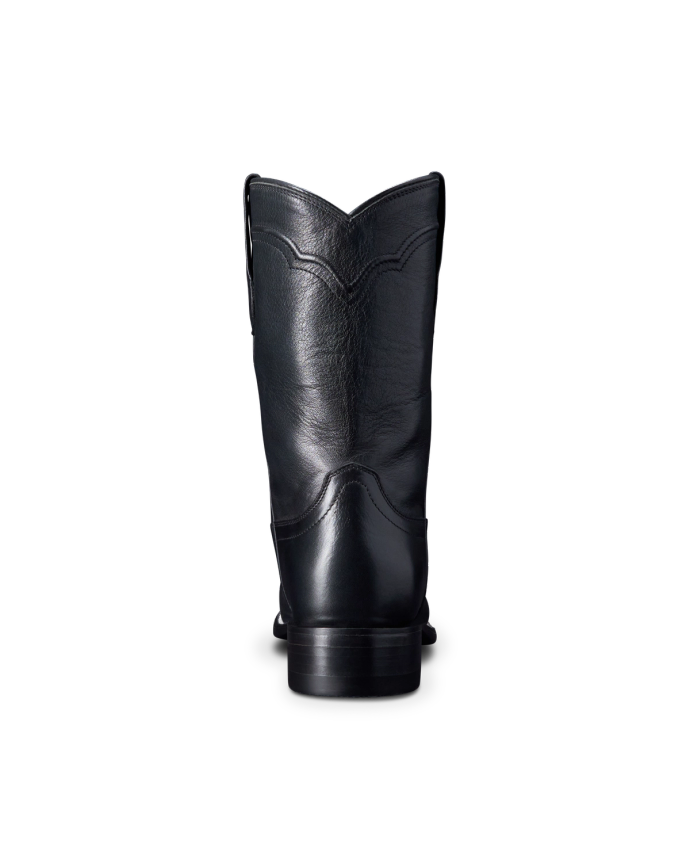 A single black leather cowboy boot viewed from the back, showcasing stitching details and a low heel, against a black background.