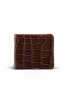 A brown leather wallet with a crocodile skin pattern, shown closed and standing upright against a plain white background.