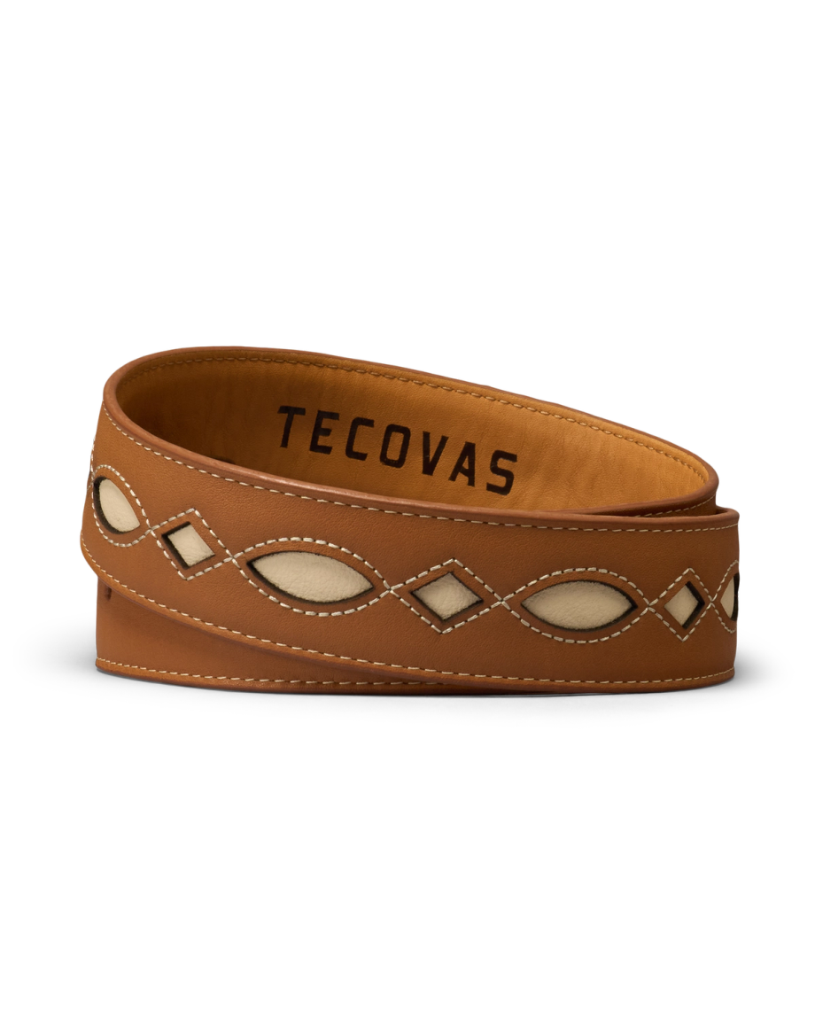 A brown leather belt with cream inlays and white stitching, featuring the brand name “Tecovas” on the inside.