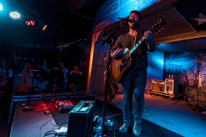 man playing guitar on stage