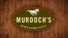 An oval sign reading "Murdoch's Ranch & Home Supply" with a horse graphic on a wooden background.