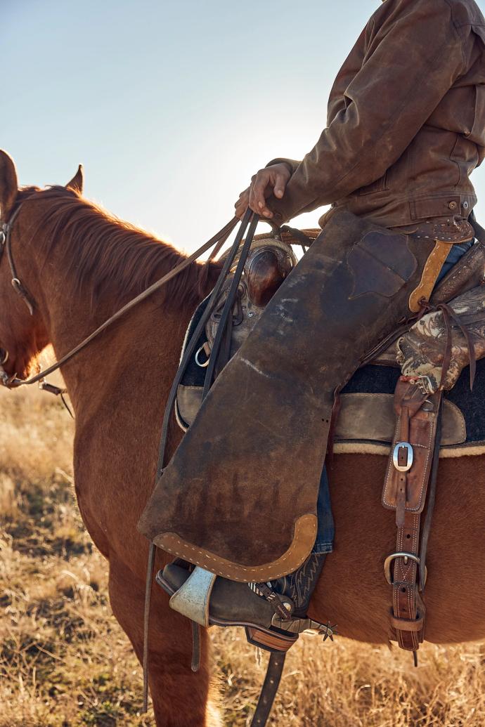 Cowboy wearing The Parker while riding a horse