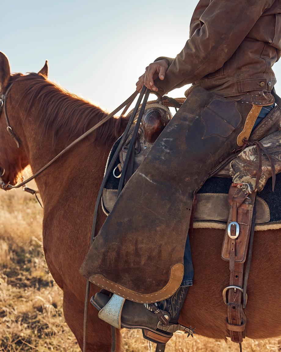 Cowboy wearing The Parker while riding a horse
