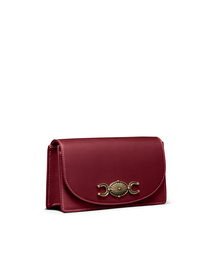 Quarterfront view of Concho Chain Crossbody - Cabernet on plain background