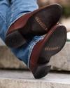close up picture of the bottom of Earl bourbon brown cowboy boots on a man's feet
